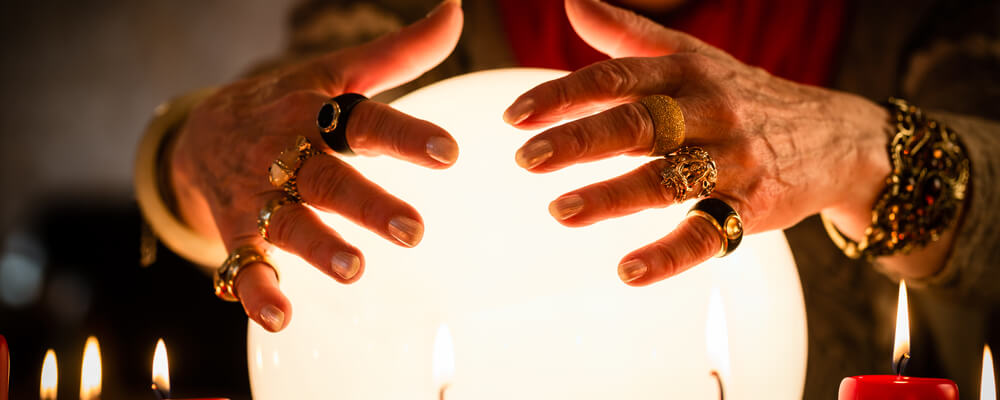 Female Fortuneteller sees in the future by looking into their crystal ball